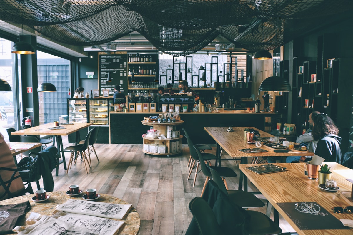 Interior of a stylish cafe and restaurant in Gaia near Porto, Portugal with wooden tables and a coffee counter