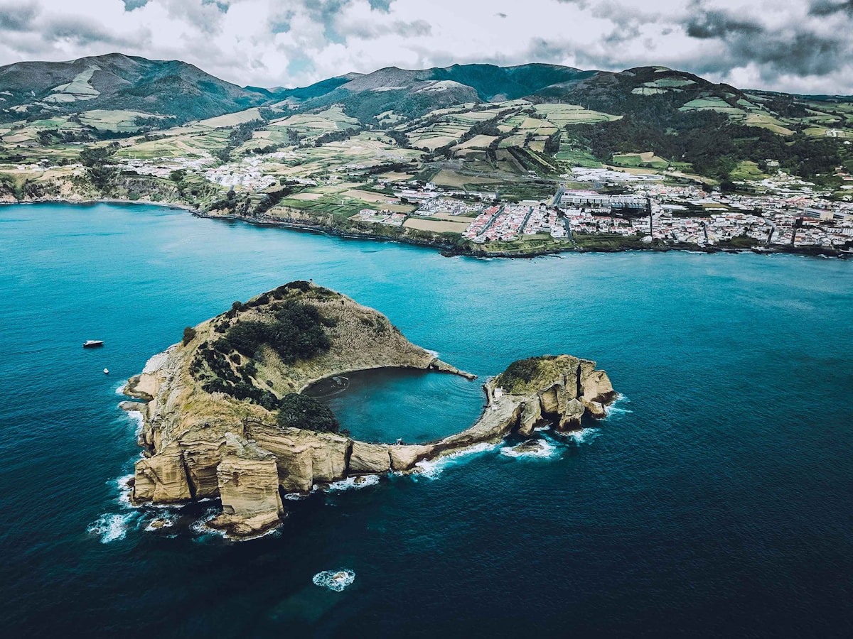 The volcanic cone of Pico mountain rising above clouds on Pico island, Azores