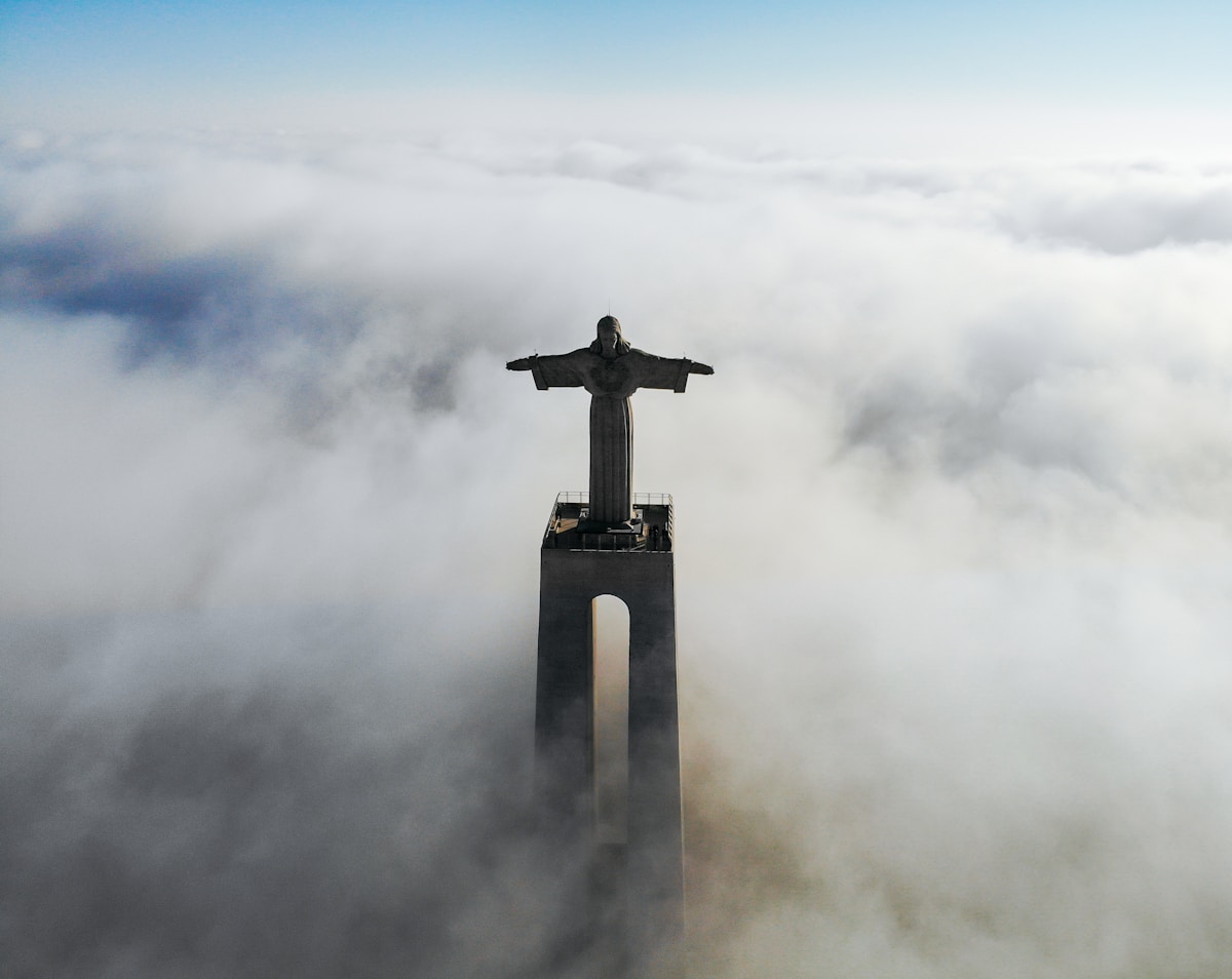 Cristo Rei statue on the south bank of the Tagus with Lisbon visible across the river